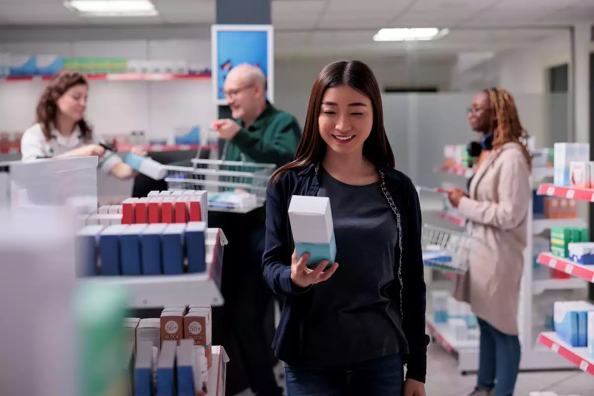 women near to cardboard display stands